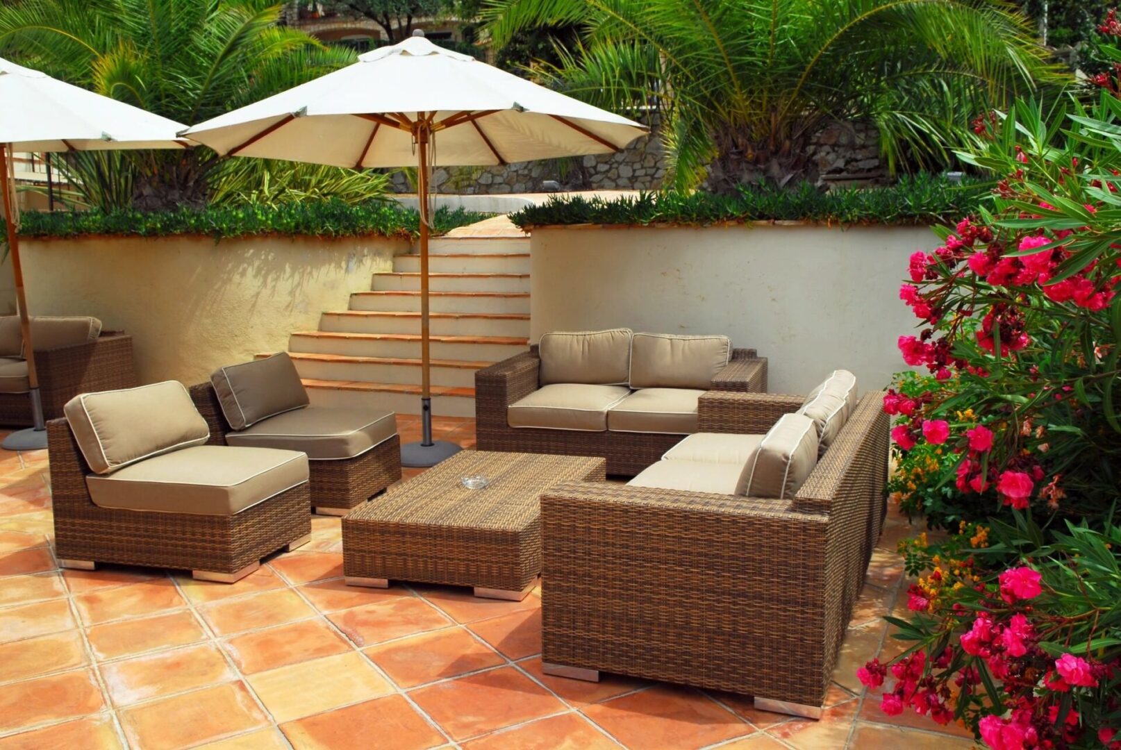 A patio with furniture and an umbrella.