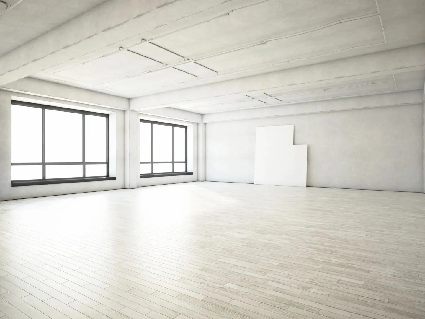 A large empty room with windows and white floors.